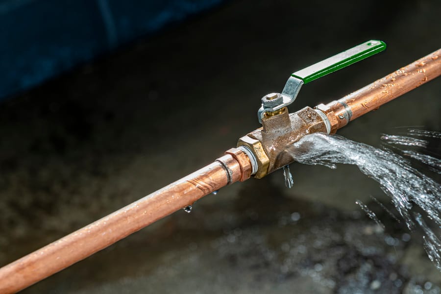 burst pipe emitting water from leak